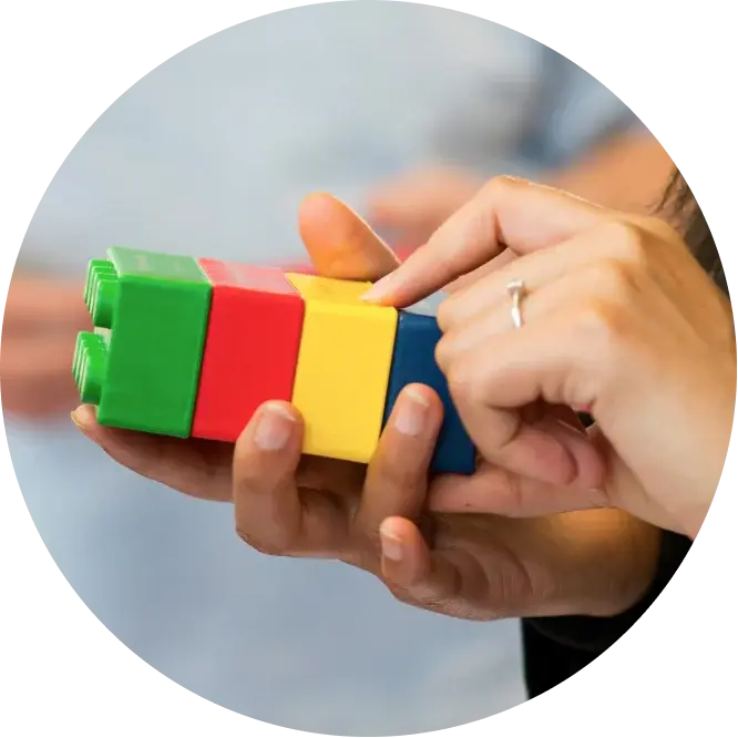 Hands holding colored blocks